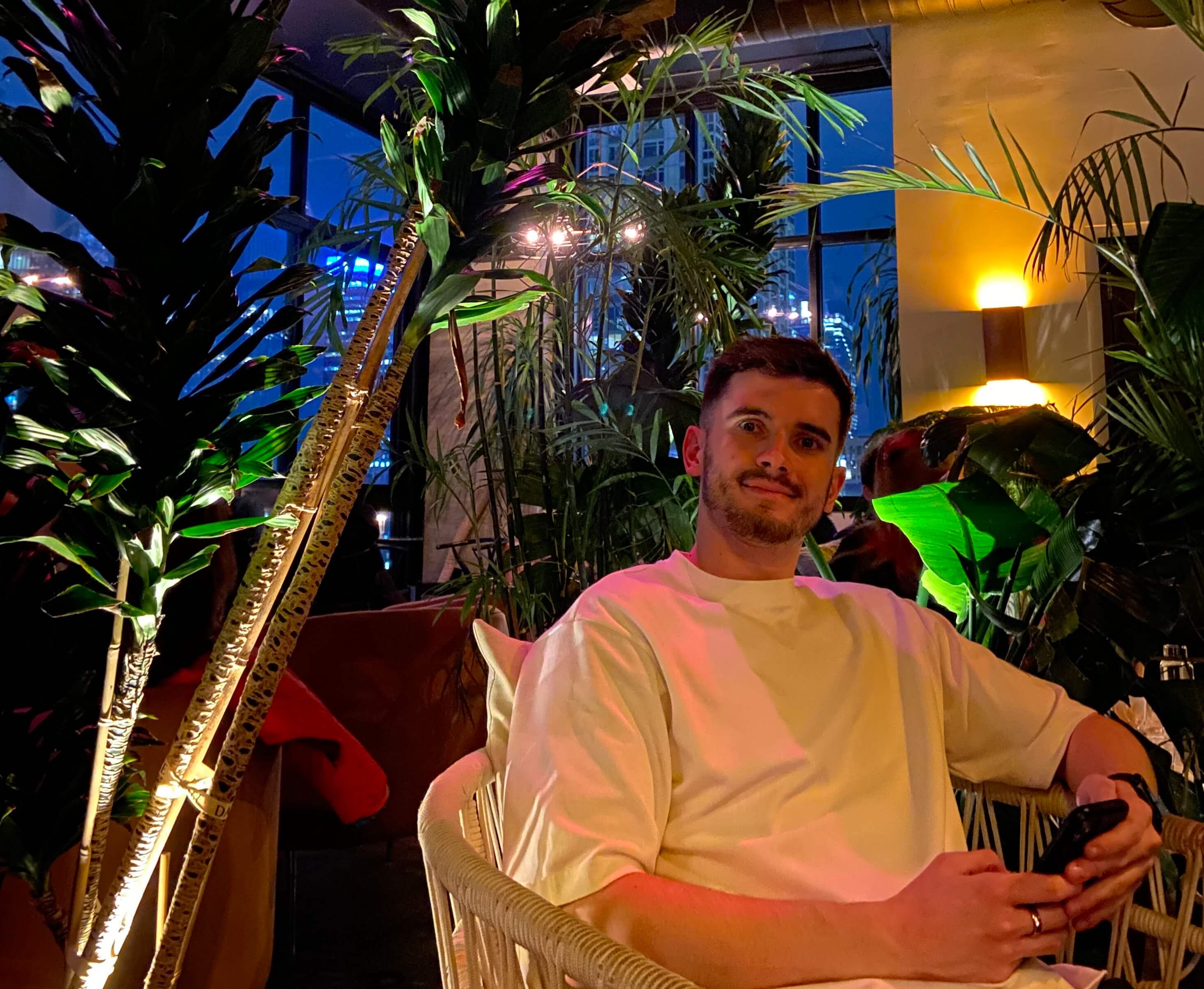 Ben sitting by trees in a restaurant